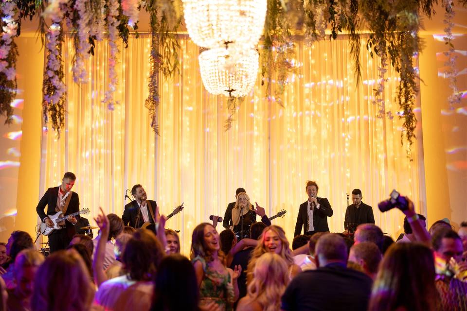 Wedding band performing on stage at elegant reception